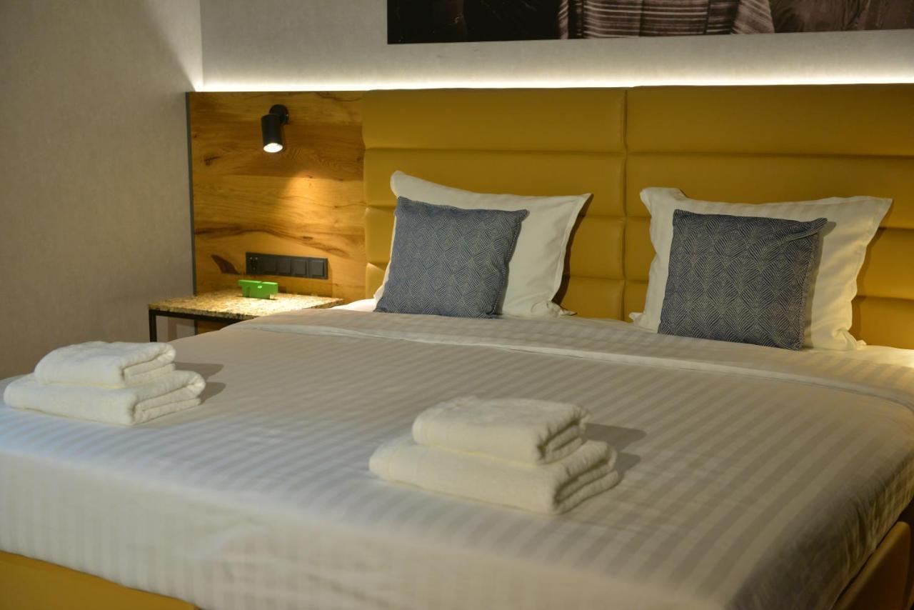 mk hotel tirana Rinas Bagian luar foto A bed with a headboard